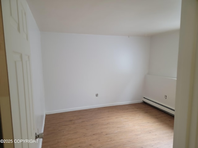 3505 Iowa St, Anchorage, AK 99517 - empty room with baseboards, baseboard heating, and wood finished floors