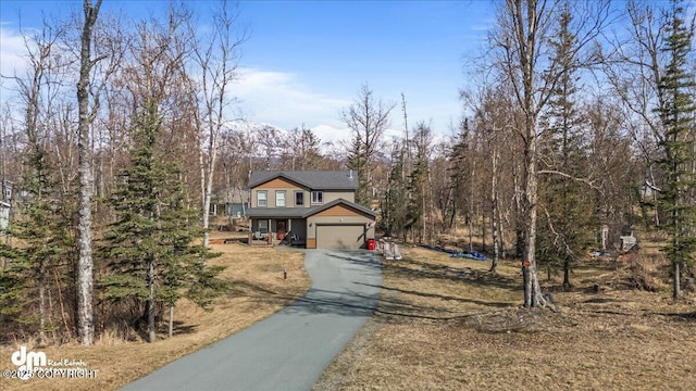 view of front of property with an attached garage and aphalt driveway