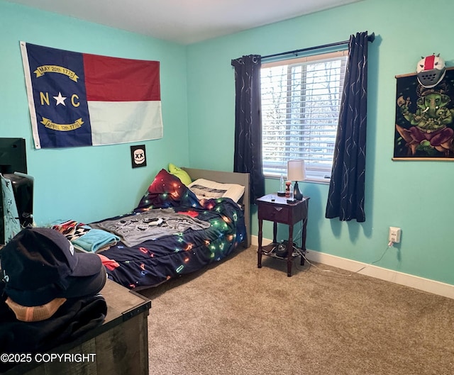 bedroom featuring carpet floors and baseboards