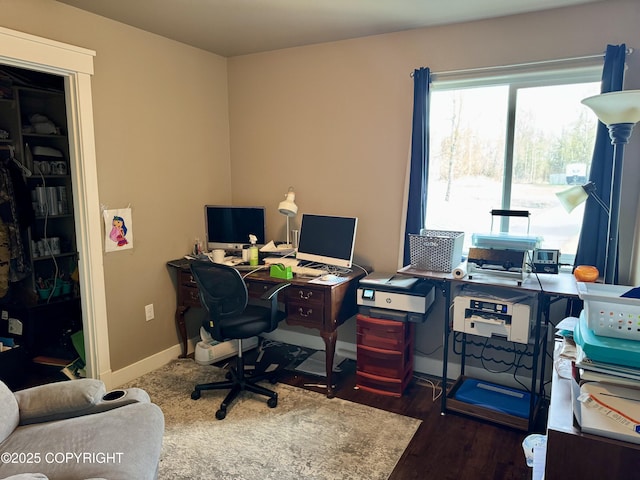 office with baseboards and dark wood-style flooring
