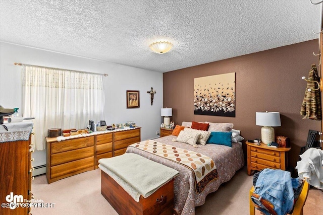 bedroom featuring a baseboard heating unit, a textured ceiling, and light carpet
