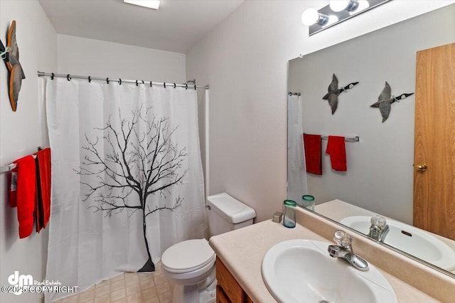bathroom featuring toilet, vanity, and a shower with shower curtain