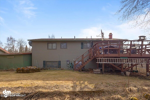 rear view of house featuring a chimney, a wooden deck, and stairway