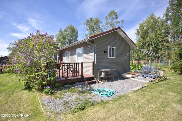 104 Beech Ave, Kenai, AK 99611 - rear view of property featuring a wooden deck and a yard