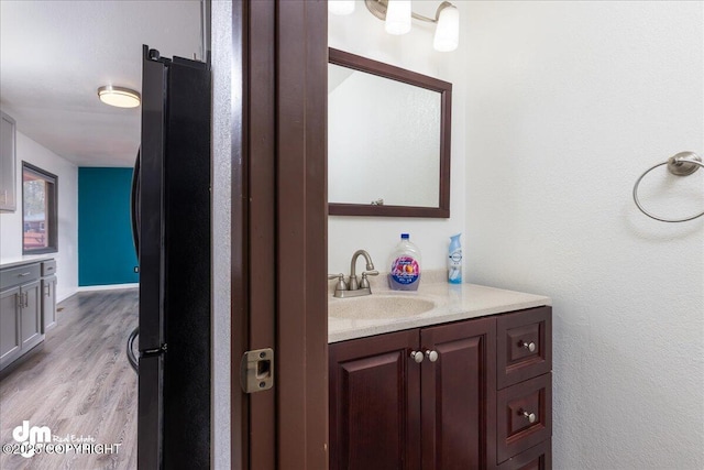 bathroom featuring vanity and wood finished floors