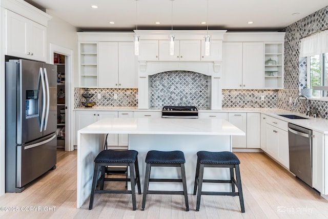 3030 E Sandman Cir, Wasilla, AK 99654 - kitchen featuring open shelves, appliances with stainless steel finishes, a sink, a kitchen breakfast bar, and light countertops