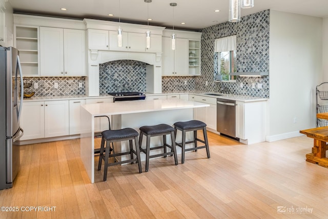 3030 E Sandman Cir, Wasilla, AK 99654 - kitchen with appliances with stainless steel finishes, light countertops, a kitchen breakfast bar, decorative backsplash, and recessed lighting