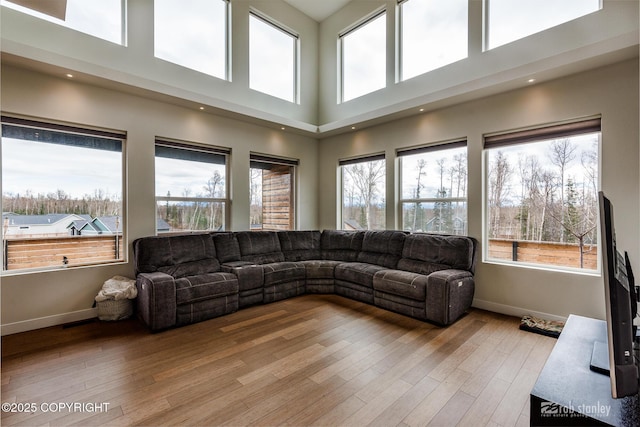 3030 E Sandman Cir, Wasilla, AK 99654 - living room with baseboards, healthy amount of natural light, light wood-style floors, and a high ceiling