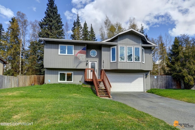 bi-level home with an attached garage and concrete driveway