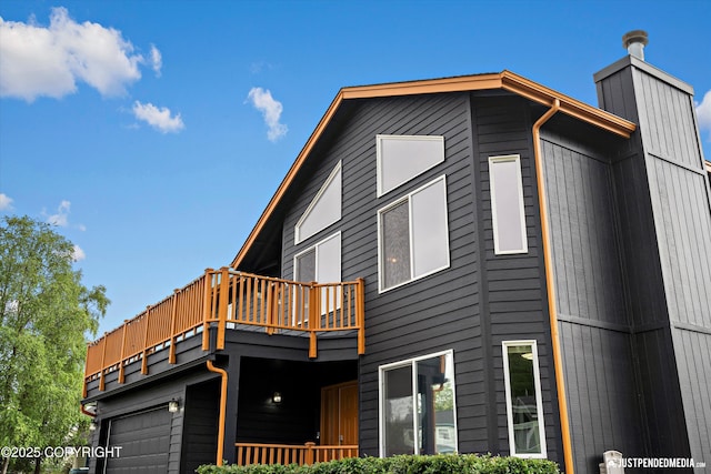800 Howard Cir, Anchorage, AK 99504 - view of home's exterior with a garage and a chimney