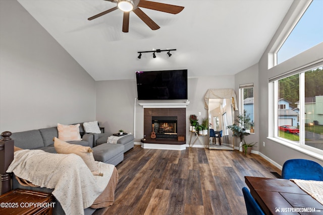 800 Howard Cir, Anchorage, AK 99504 - living room featuring vaulted ceiling, ceiling fan, wood finished floors, a tile fireplace, and track lighting