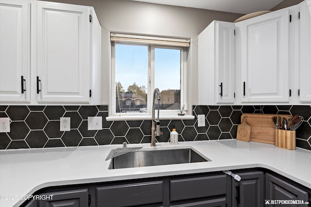 800 Howard Cir, Anchorage, AK 99504 - kitchen featuring a sink, white cabinetry, and backsplash