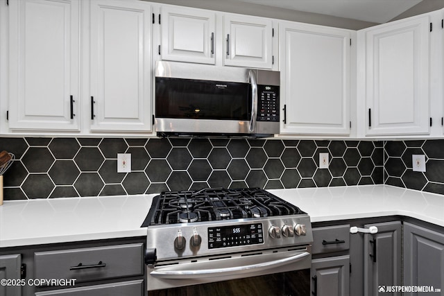 800 Howard Cir, Anchorage, AK 99504 - kitchen featuring stainless steel appliances, gray cabinetry, decorative backsplash, and white cabinetry