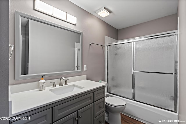 800 Howard Cir, Anchorage, AK 99504 - full bathroom featuring toilet, vanity, enclosed tub / shower combo, and wood finished floors