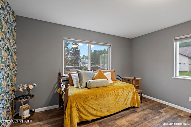 800 Howard Cir, Anchorage, AK 99504 - bedroom with wood finished floors, multiple windows, and baseboards