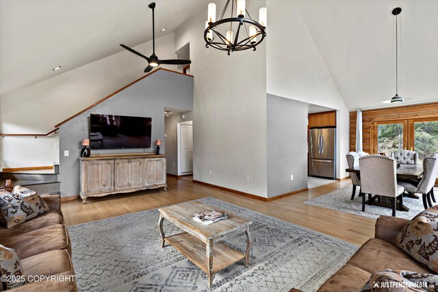 3915 Hiland Rd, Eagle River, AK 99577 - living area with high vaulted ceiling, a chandelier, ceiling fan, baseboards, and light wood-type flooring