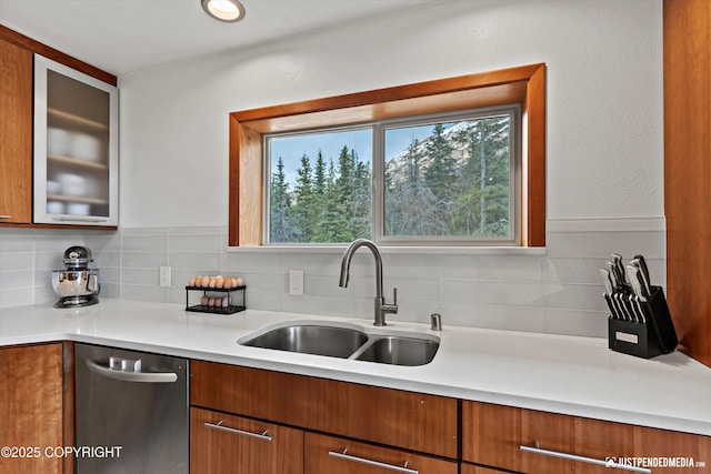 3915 Hiland Rd, Eagle River, AK 99577 - kitchen featuring stainless steel dishwasher, a sink, light countertops, and decorative backsplash