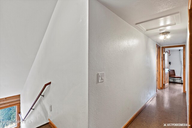 3915 Hiland Rd, Eagle River, AK 99577 - hallway featuring an upstairs landing, a textured wall, baseboards, and attic access