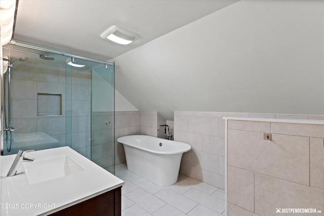 3915 Hiland Rd, Eagle River, AK 99577 - full bath featuring tile walls, a shower stall, tile patterned flooring, a freestanding bath, and vanity