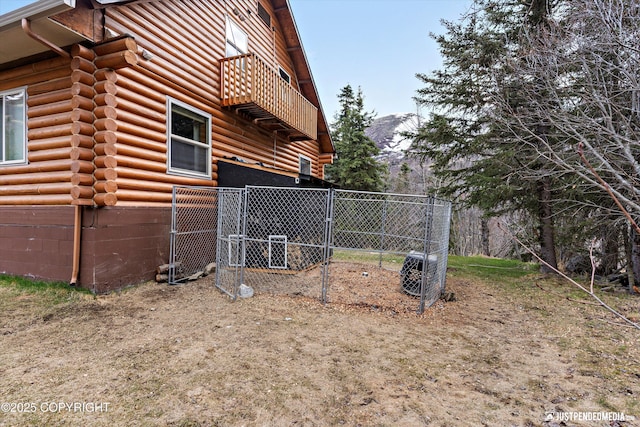 3915 Hiland Rd, Eagle River, AK 99577 - view of home's exterior with log exterior, a balcony, a gate, fence, and crawl space