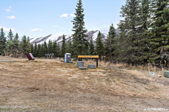 3915 Hiland Rd, Eagle River, AK 99577 - view of yard featuring a mountain view and a wooded view