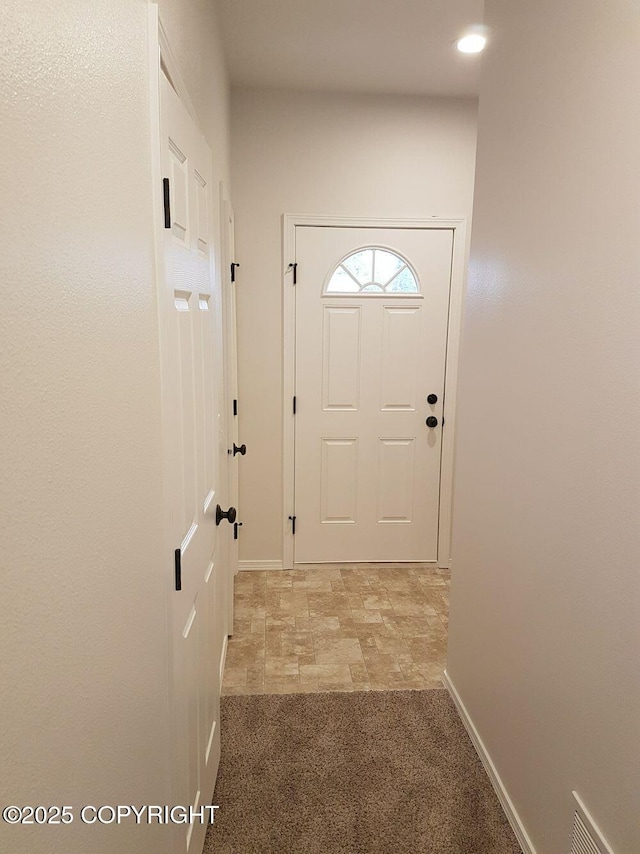 doorway featuring baseboards, recessed lighting, visible vents, and light colored carpet