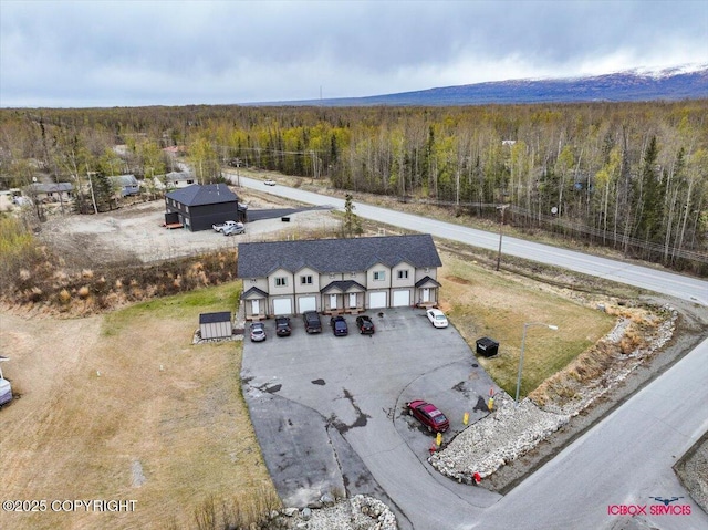 birds eye view of property with a wooded view