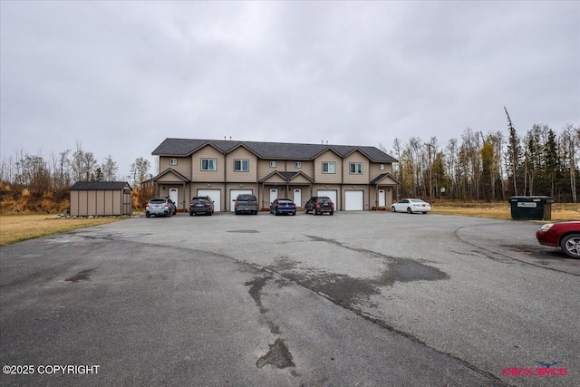 view of front of property with a storage unit and an outbuilding