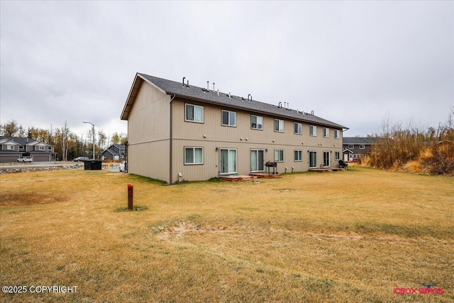 back of property featuring a yard