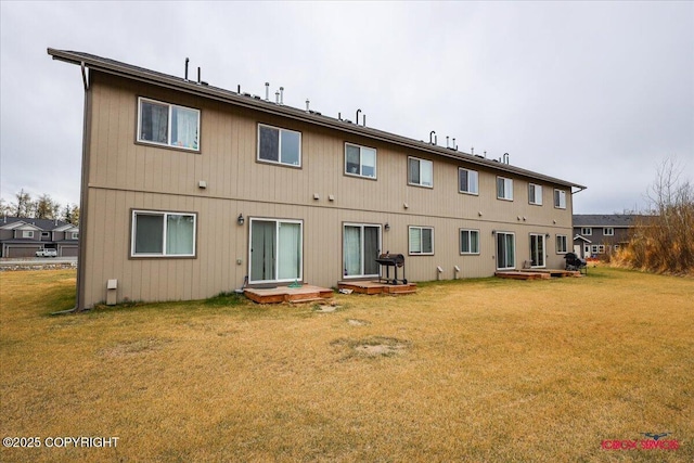 rear view of property featuring a yard