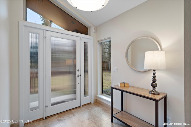 entryway featuring vaulted ceiling and light tile patterned floors