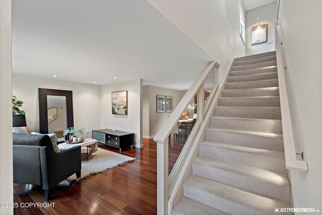 stairs with recessed lighting and wood finished floors