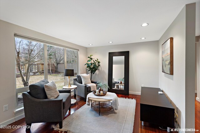 living room with recessed lighting, baseboards, and wood finished floors