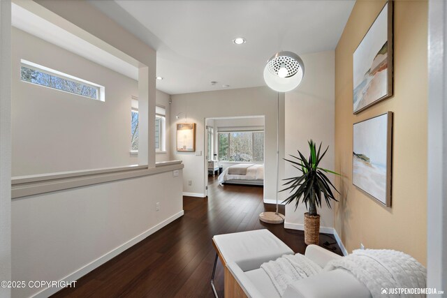 hallway featuring recessed lighting, baseboards, and dark wood-style floors