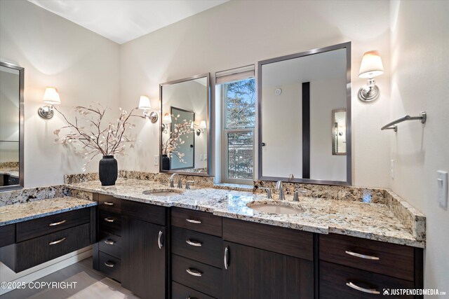 full bathroom featuring double vanity and a sink