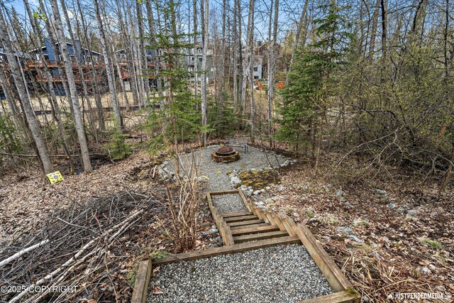 view of yard with an outdoor fire pit
