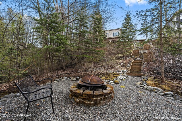 view of yard featuring an outdoor fire pit