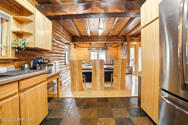 17720 Werre St, Chugiak, AK 99567 - kitchen featuring freestanding refrigerator, log walls, beamed ceiling, wood ceiling, and stone tile floors