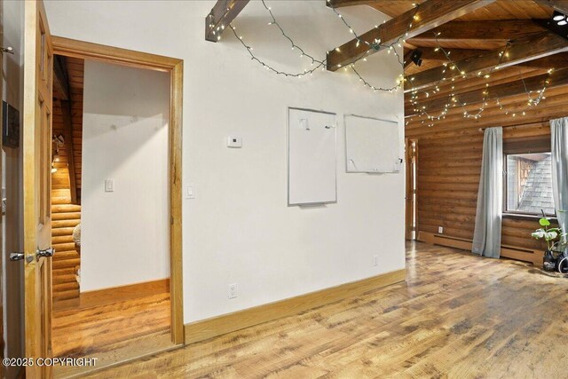 17720 Werre St, Chugiak, AK 99567 - spare room with log walls, wood finished floors, and beamed ceiling