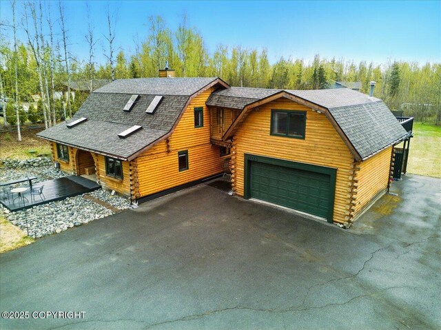 17720 Werre St, Chugiak, AK 99567 - log cabin with log exterior, a gambrel roof, roof with shingles, and asphalt driveway