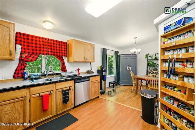 1900 N Green Forest Dr, Palmer, AK 99645 - kitchen featuring stainless steel dishwasher, a chandelier, light wood finished floors, tile counters, and pendant lighting