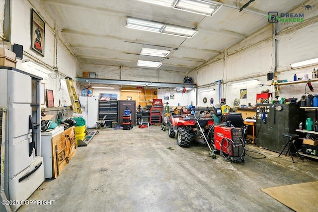 1900 N Green Forest Dr, Palmer, AK 99645 - garage with a workshop area, freestanding refrigerator, white fridge with ice dispenser, and washer / clothes dryer