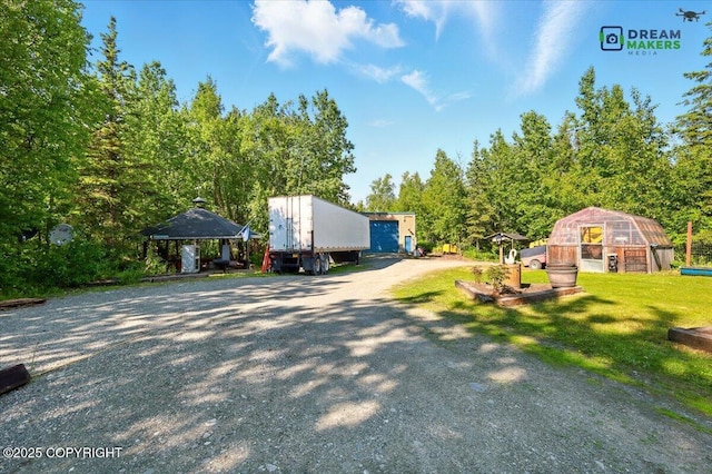 1900 N Green Forest Dr, Palmer, AK 99645 - view of property exterior with an exterior structure, an outdoor structure, and a lawn