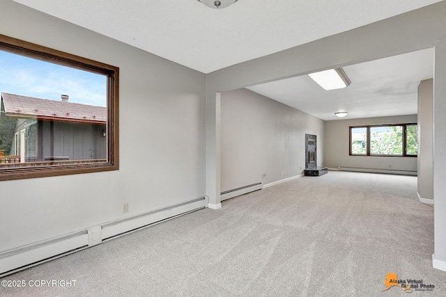 3211 Shamrock St, Anchorage, AK 99504 - unfurnished room with a baseboard heating unit and carpet