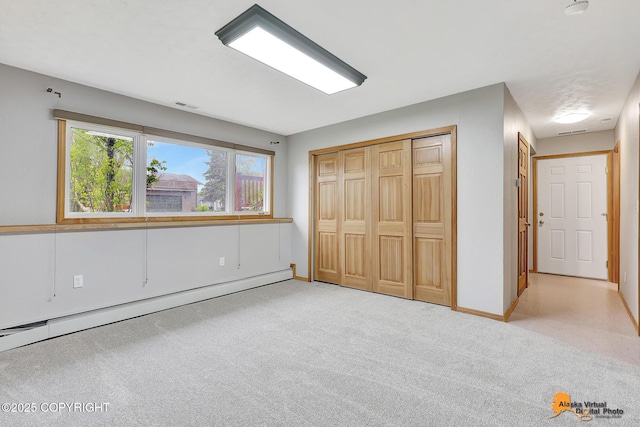 3211 Shamrock St, Anchorage, AK 99504 - unfurnished bedroom featuring a baseboard radiator, carpet, and a closet