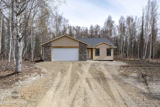 7177 N Paw St, Wasilla, AK 99654 - single story home featuring a shingled roof, dirt driveway, an attached garage, and stone siding