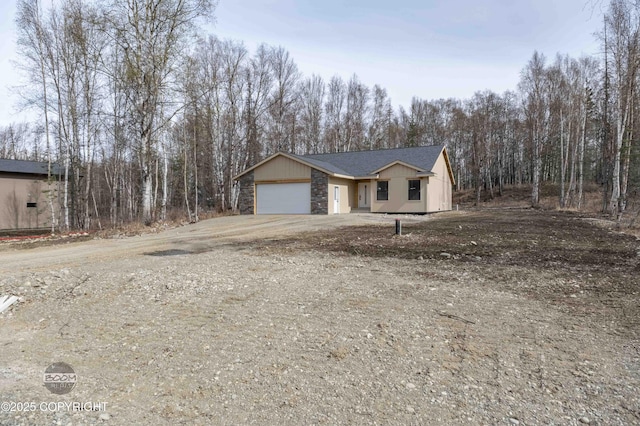7177 N Paw St, Wasilla, AK 99654 - ranch-style house with driveway, stone siding, and a garage