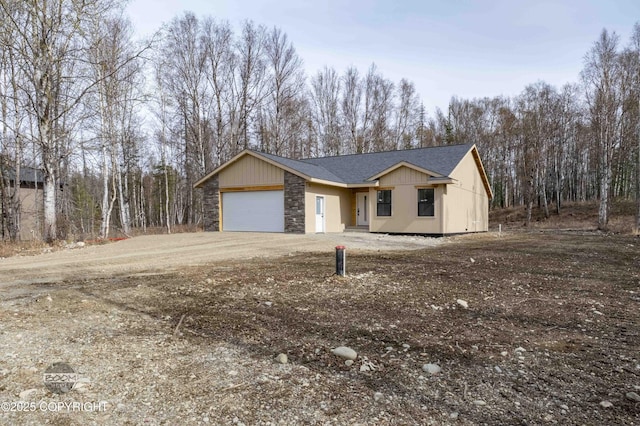7177 N Paw St, Wasilla, AK 99654 - ranch-style home with a garage, a shingled roof, driveway, and stone siding