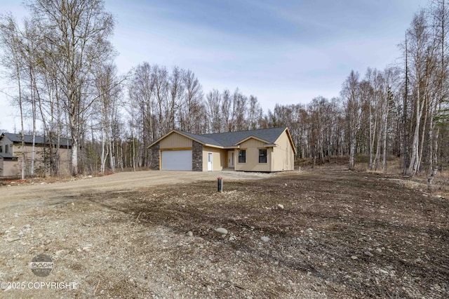 7177 N Paw St, Wasilla, AK 99654 - view of front of house featuring a garage and driveway