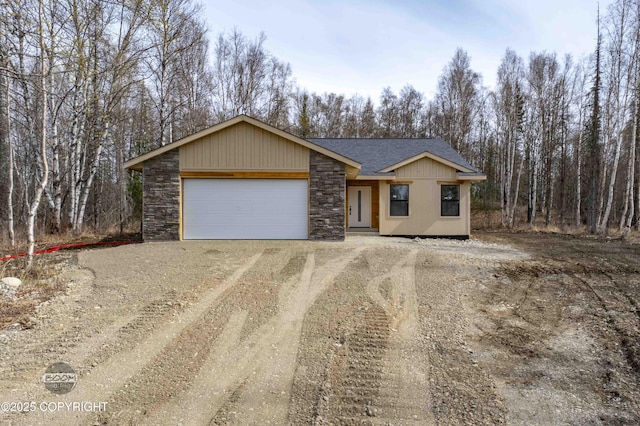 7177 N Paw St, Wasilla, AK 99654 - single story home featuring an attached garage, a shingled roof, driveway, and stone siding